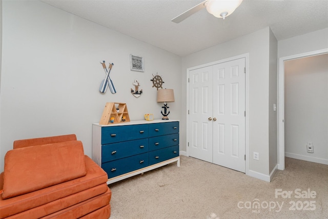 sitting room with light carpet, baseboards, and ceiling fan