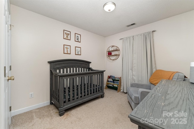 bedroom featuring baseboards, visible vents, and carpet