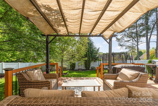 wooden deck featuring a fenced backyard, a pergola, an outdoor hangout area, and a trampoline