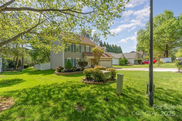 view of front of home with an attached garage, a front yard, concrete driveway, and fence