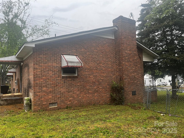 view of property exterior featuring crawl space, a chimney, fence, brick siding, and a gate