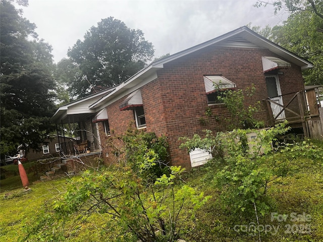 view of side of property featuring brick siding