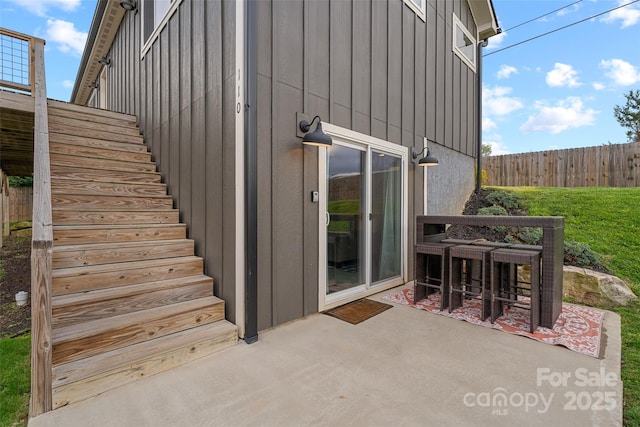110 Hayden Way, Asheville, NC 28803 - view of exterior entry featuring a patio area, fence, and board and batten siding