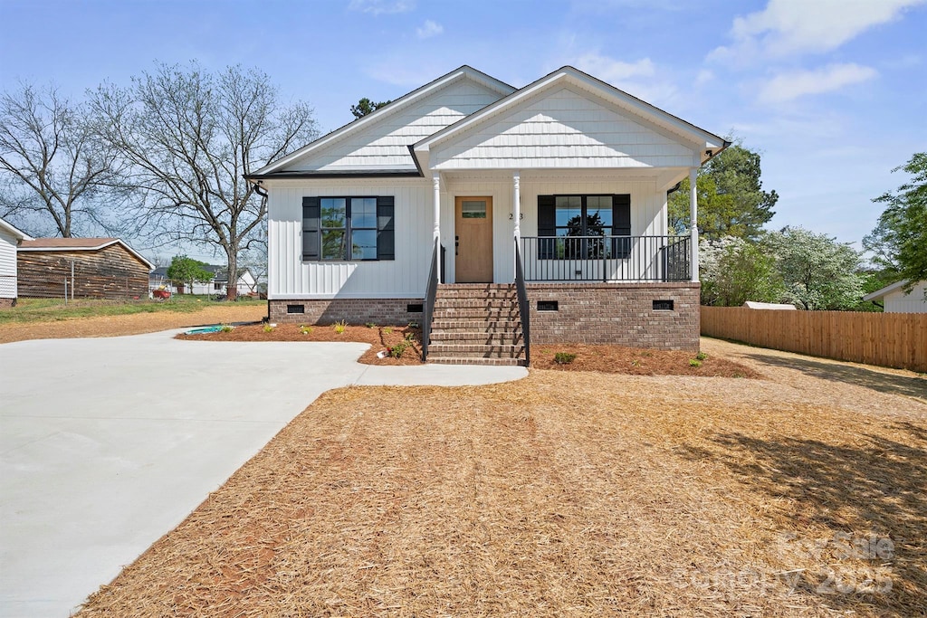 203 E 27th St, Kannapolis, NC 28083 - view of front of property featuring concrete driveway, crawl space, fence, and covered porch