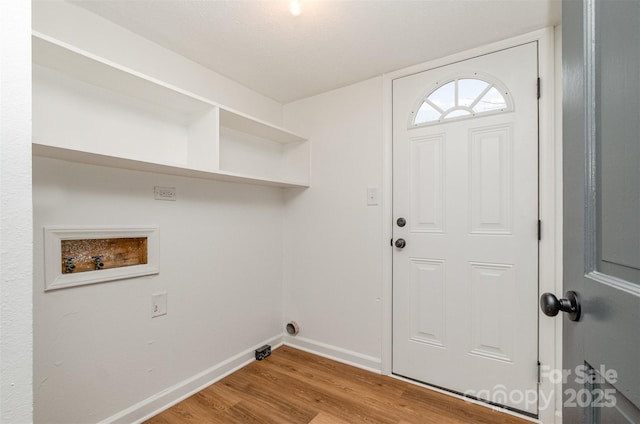 laundry area with laundry area, wood finished floors, baseboards, and hookup for a washing machine