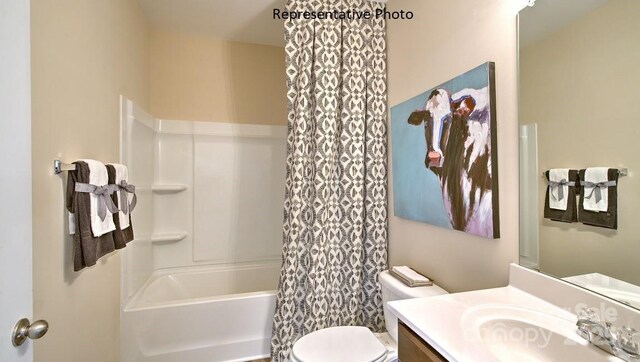 bathroom featuring vanity, shower / bath combination with curtain, and toilet