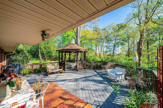 wooden terrace with grilling area and a gazebo