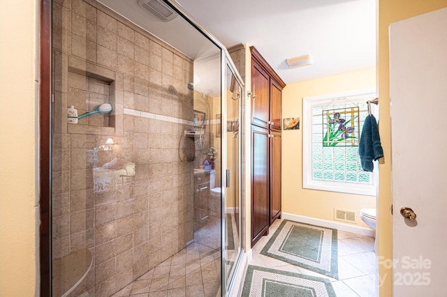 full bath featuring visible vents, tile patterned flooring, a stall shower, baseboards, and toilet