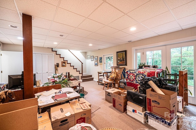 living room with carpet flooring, recessed lighting, a drop ceiling, and stairway