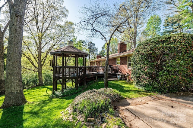 view of yard with a wooden deck and a gazebo