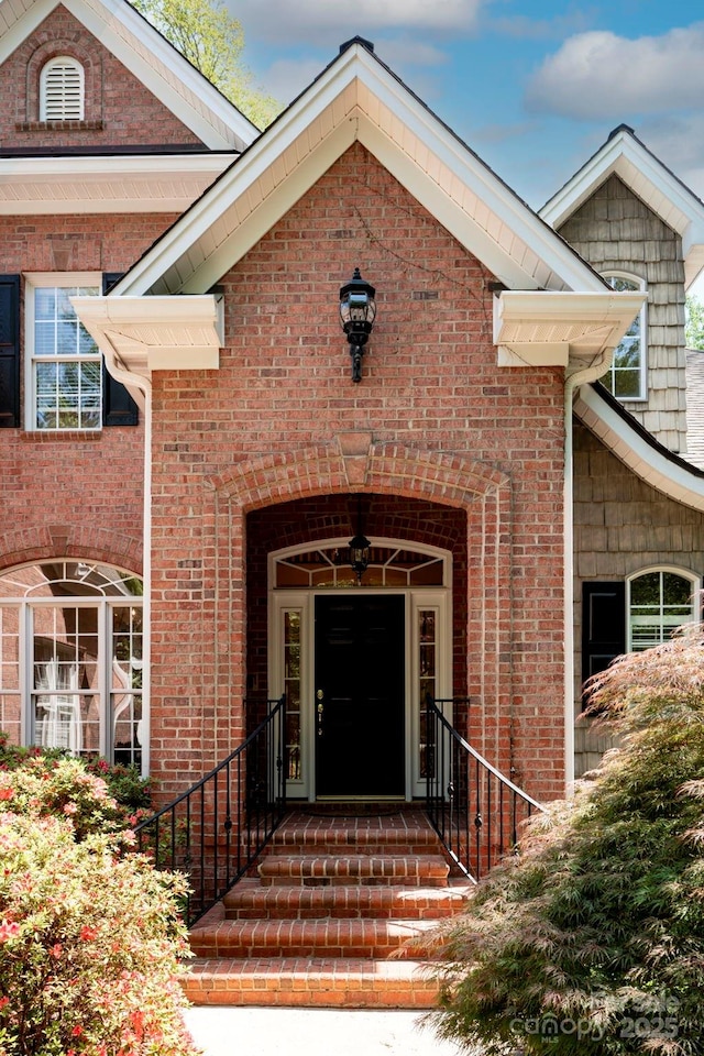 property entrance featuring brick siding