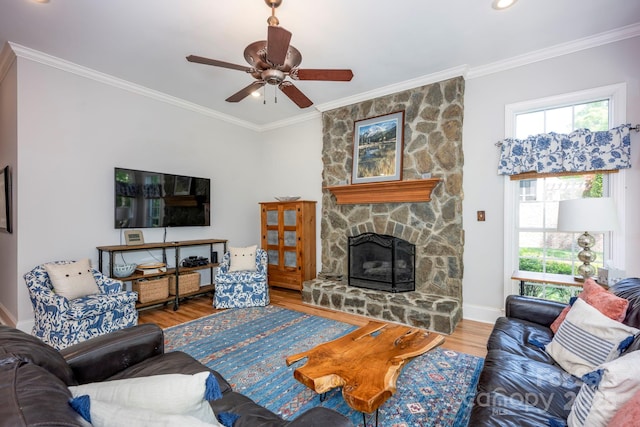 living area with wood finished floors, a ceiling fan, and crown molding
