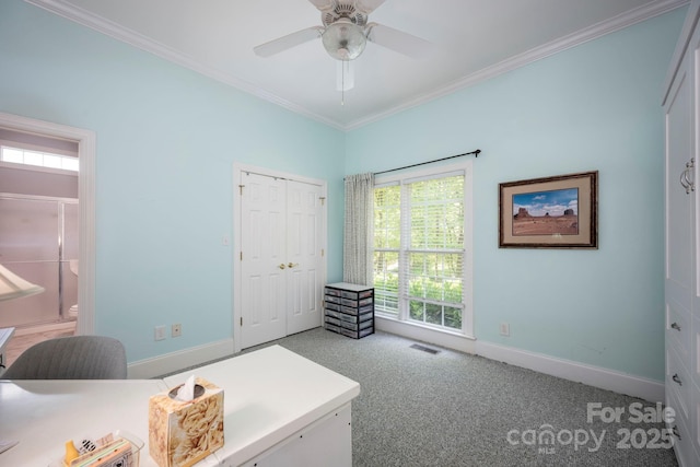 carpeted office with ceiling fan, crown molding, visible vents, and baseboards