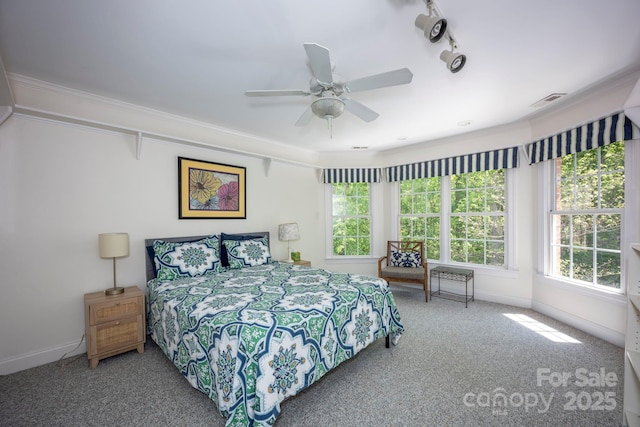 carpeted bedroom featuring crown molding, visible vents, ceiling fan, and baseboards