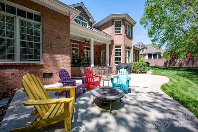 view of patio / terrace with an outdoor fire pit, ceiling fan, and area for grilling