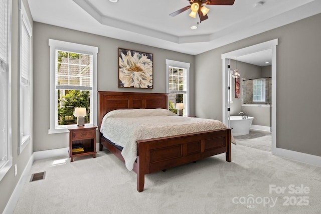 bedroom with visible vents, multiple windows, and light colored carpet