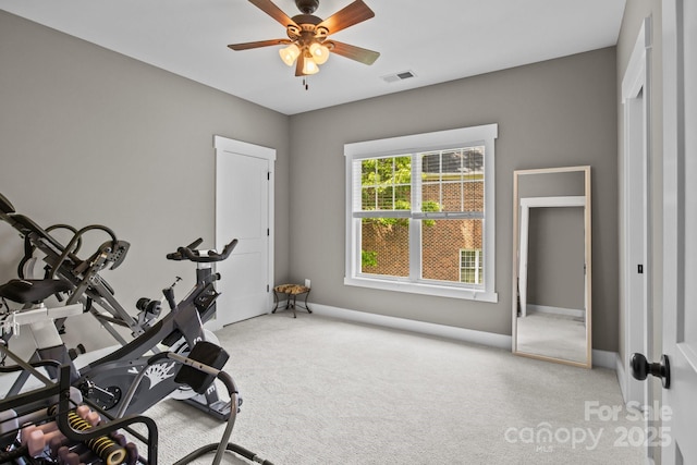 exercise room featuring carpet floors, ceiling fan, visible vents, and baseboards