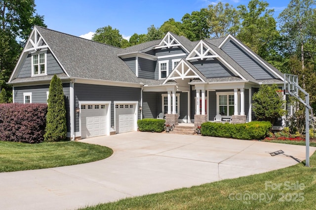 craftsman-style home featuring an attached garage, roof with shingles, covered porch, and concrete driveway