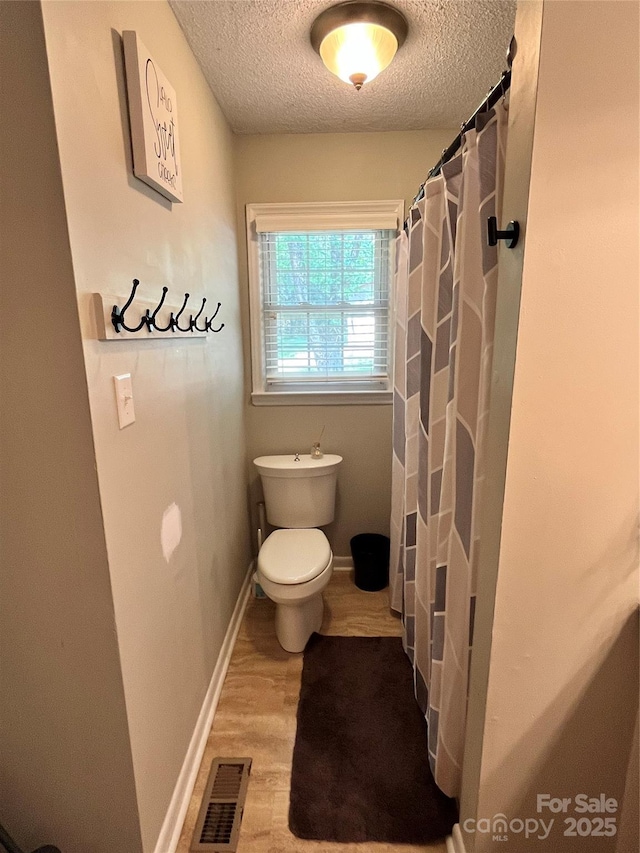 1780 Short St, Mount Pleasant, NC 28124 - bathroom with a textured ceiling, toilet, wood finished floors, and a shower with shower curtain
