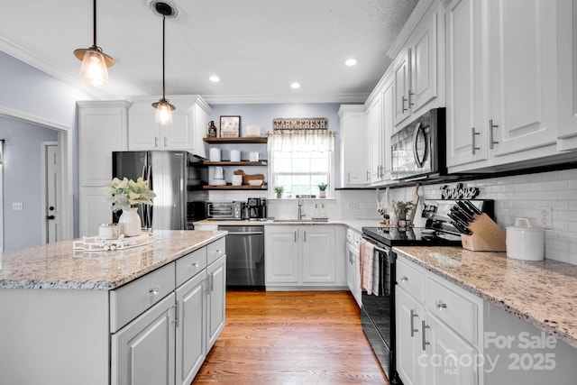 kitchen with open shelves, a sink, white cabinetry, stainless steel appliances, and light wood-style flooring