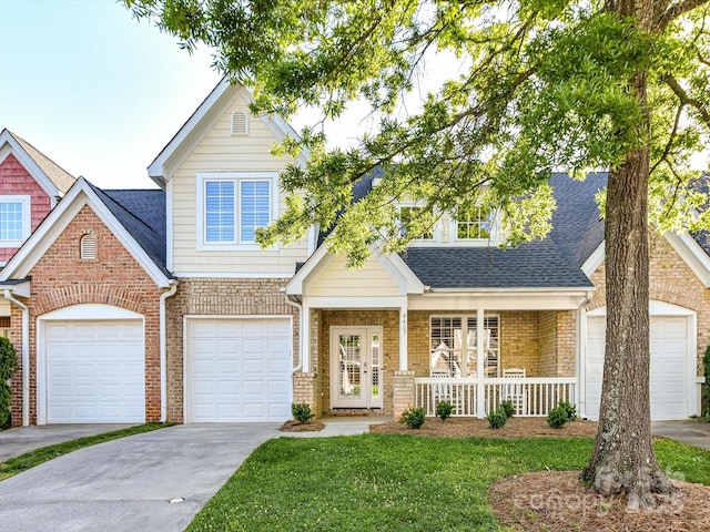 view of front of home with a porch, brick siding, a garage, a front lawn, and concrete driveway