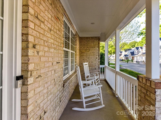 view of patio / terrace with a residential view and covered porch