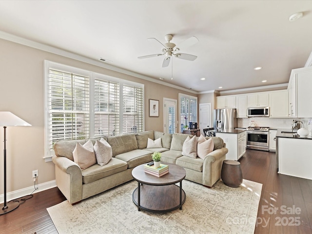 living room with crown molding, visible vents, recessed lighting, dark wood-type flooring, and a ceiling fan