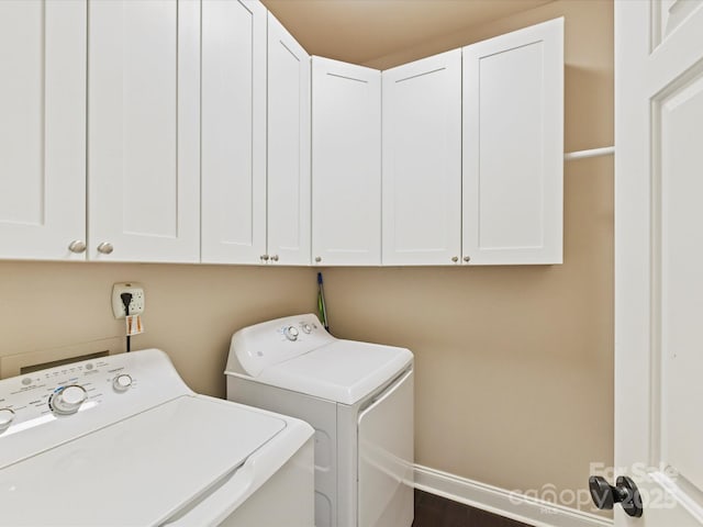 laundry room featuring cabinet space, independent washer and dryer, and baseboards