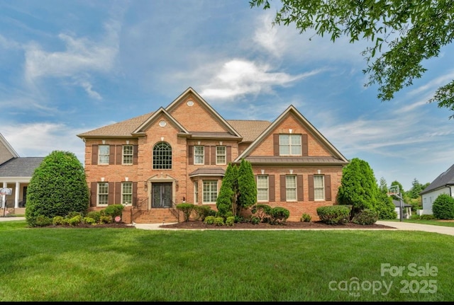 9008 Skipaway Dr, Waxhaw, NC 28173 - colonial-style house with a front lawn and brick siding