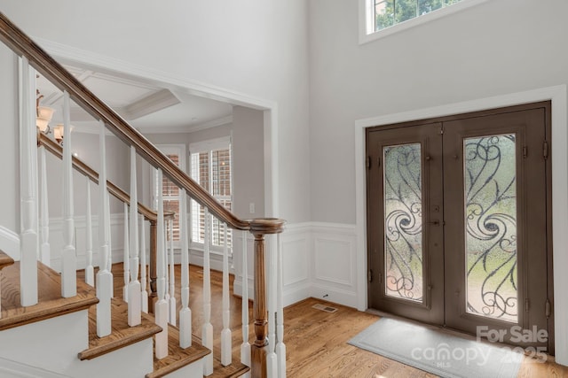 9008 Skipaway Dr, Waxhaw, NC 28173 - entrance foyer featuring french doors, stairway, light wood-style flooring, wainscoting, and ornamental molding