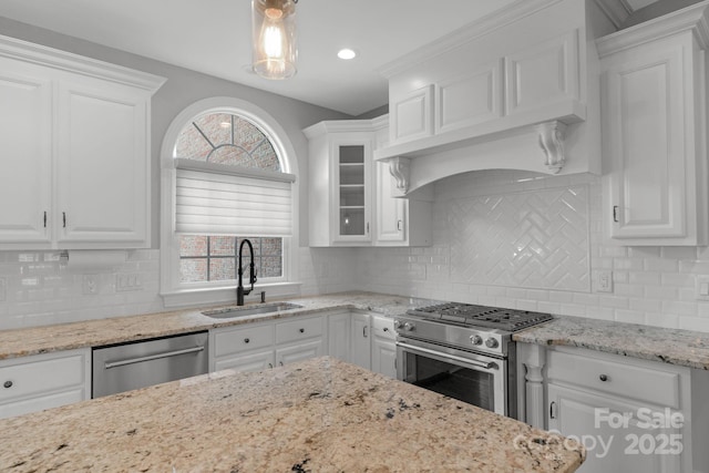9008 Skipaway Dr, Waxhaw, NC 28173 - kitchen with a sink, appliances with stainless steel finishes, white cabinets, backsplash, and recessed lighting