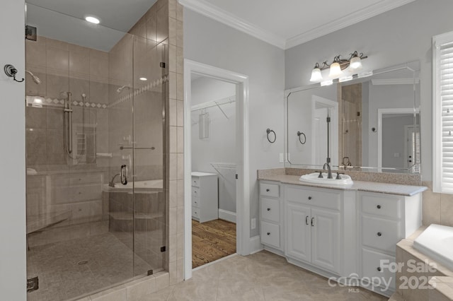 9008 Skipaway Dr, Waxhaw, NC 28173 - bathroom with a shower stall, vanity, ornamental molding, a relaxing tiled tub, and a spacious closet
