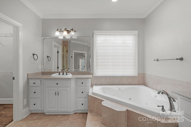 9008 Skipaway Dr, Waxhaw, NC 28173 - bathroom with vanity, a whirlpool tub, crown molding, a spacious closet, and tile patterned flooring
