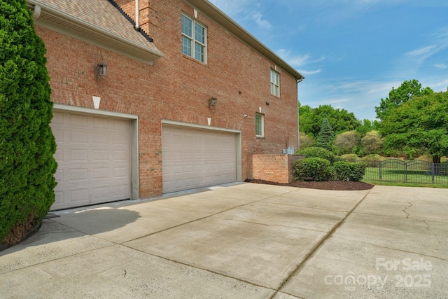 9008 Skipaway Dr, Waxhaw, NC 28173 - view of property exterior featuring driveway, a garage, and brick siding
