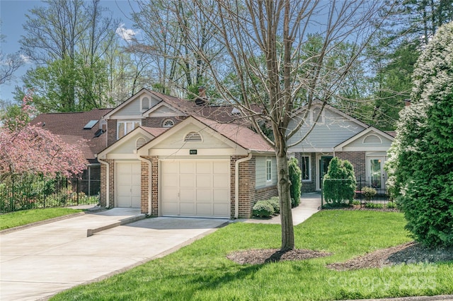 102 Glenbrook Dr, Hendersonville, NC 28739 - view of front facade featuring concrete driveway, a front yard, brick siding, and fence