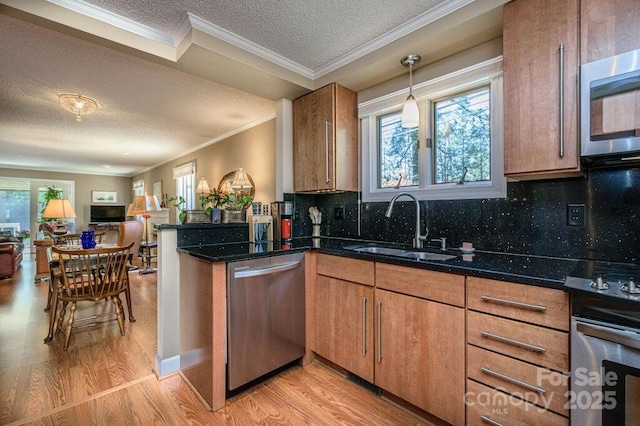 102 Glenbrook Dr, Hendersonville, NC 28739 - kitchen featuring light wood-style floors, brown cabinetry, a sink, stainless steel appliances, and open floor plan