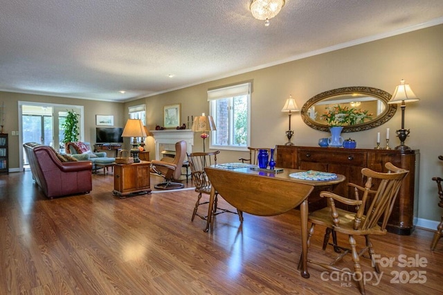 102 Glenbrook Dr, Hendersonville, NC 28739 - dining space featuring baseboards, a textured ceiling, crown molding, and wood finished floors
