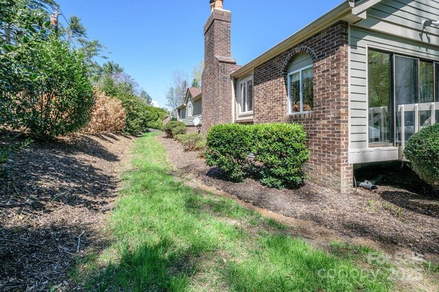 102 Glenbrook Dr, Hendersonville, NC 28739 - view of property exterior featuring a chimney and brick siding