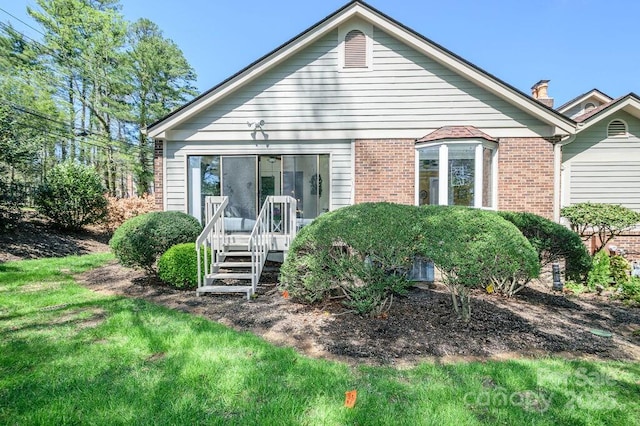 102 Glenbrook Dr, Hendersonville, NC 28739 - rear view of property with brick siding and a lawn