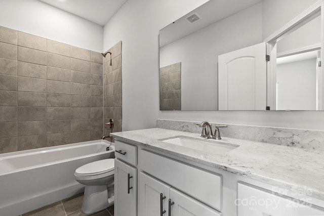 full bathroom featuring vanity, tile patterned floors, toilet, visible vents, and tub / shower combination