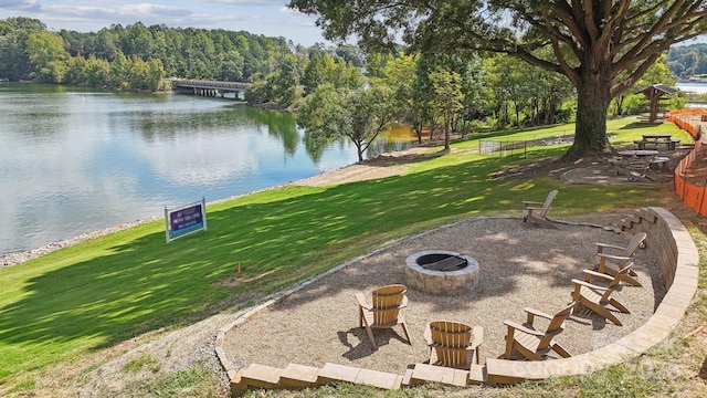 view of yard featuring a water view and an outdoor fire pit