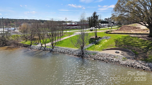 view of property's community featuring a yard and a water view