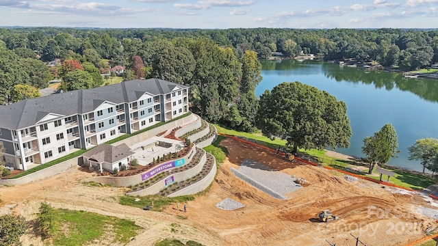 birds eye view of property with a water view and a view of trees
