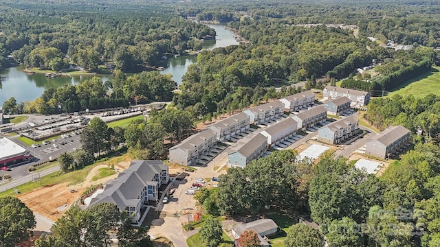 drone / aerial view featuring a water view and a view of trees