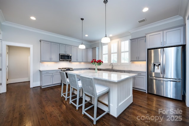 1550 Matthew Mcclure Cir, Davidson, NC 28036 - kitchen featuring appliances with stainless steel finishes, crown molding, gray cabinets, decorative backsplash, and recessed lighting