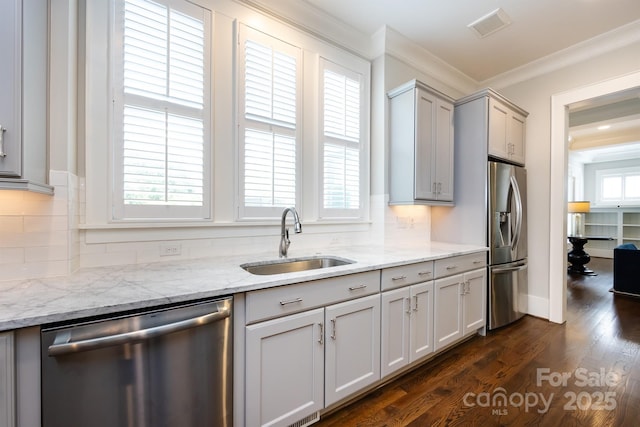 1550 Matthew Mcclure Cir, Davidson, NC 28036 - kitchen featuring stainless steel appliances, decorative backsplash, ornamental molding, dark wood-style floors, and light stone counters