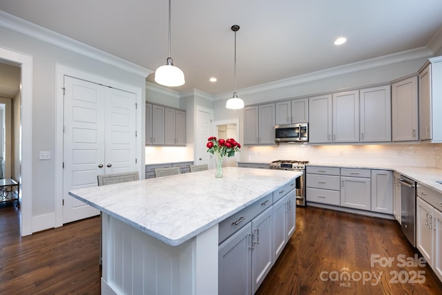 1550 Matthew Mcclure Cir, Davidson, NC 28036 - kitchen with stainless steel appliances, gray cabinetry, ornamental molding, light stone countertops, and decorative backsplash