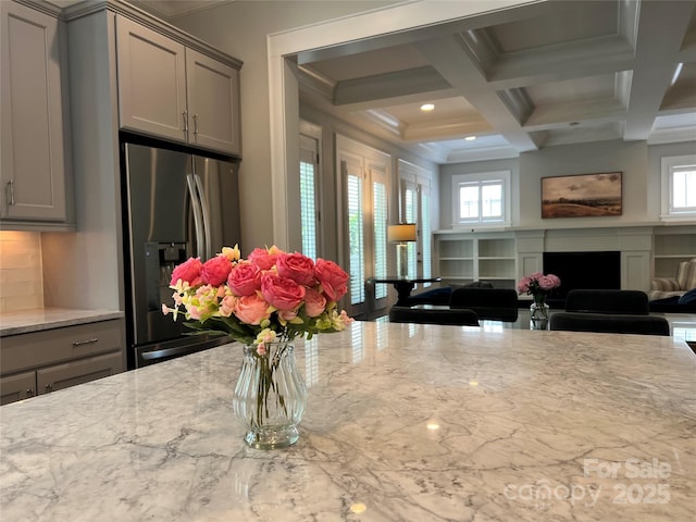 1550 Matthew Mcclure Cir, Davidson, NC 28036 - kitchen with stainless steel refrigerator with ice dispenser, gray cabinetry, a fireplace, coffered ceiling, and beam ceiling