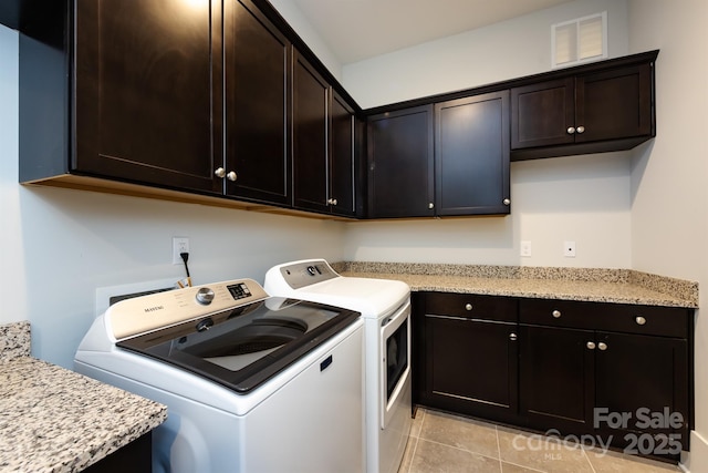 1550 Matthew Mcclure Cir, Davidson, NC 28036 - laundry area with washing machine and clothes dryer, cabinet space, and light tile patterned floors