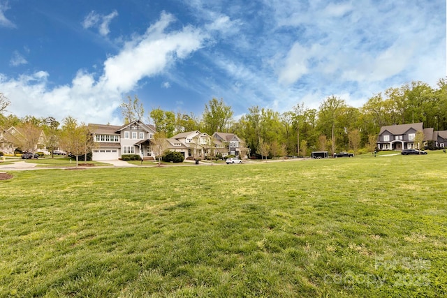 1550 Matthew Mcclure Cir, Davidson, NC 28036 - view of green lawn featuring an attached garage, a residential view, and driveway